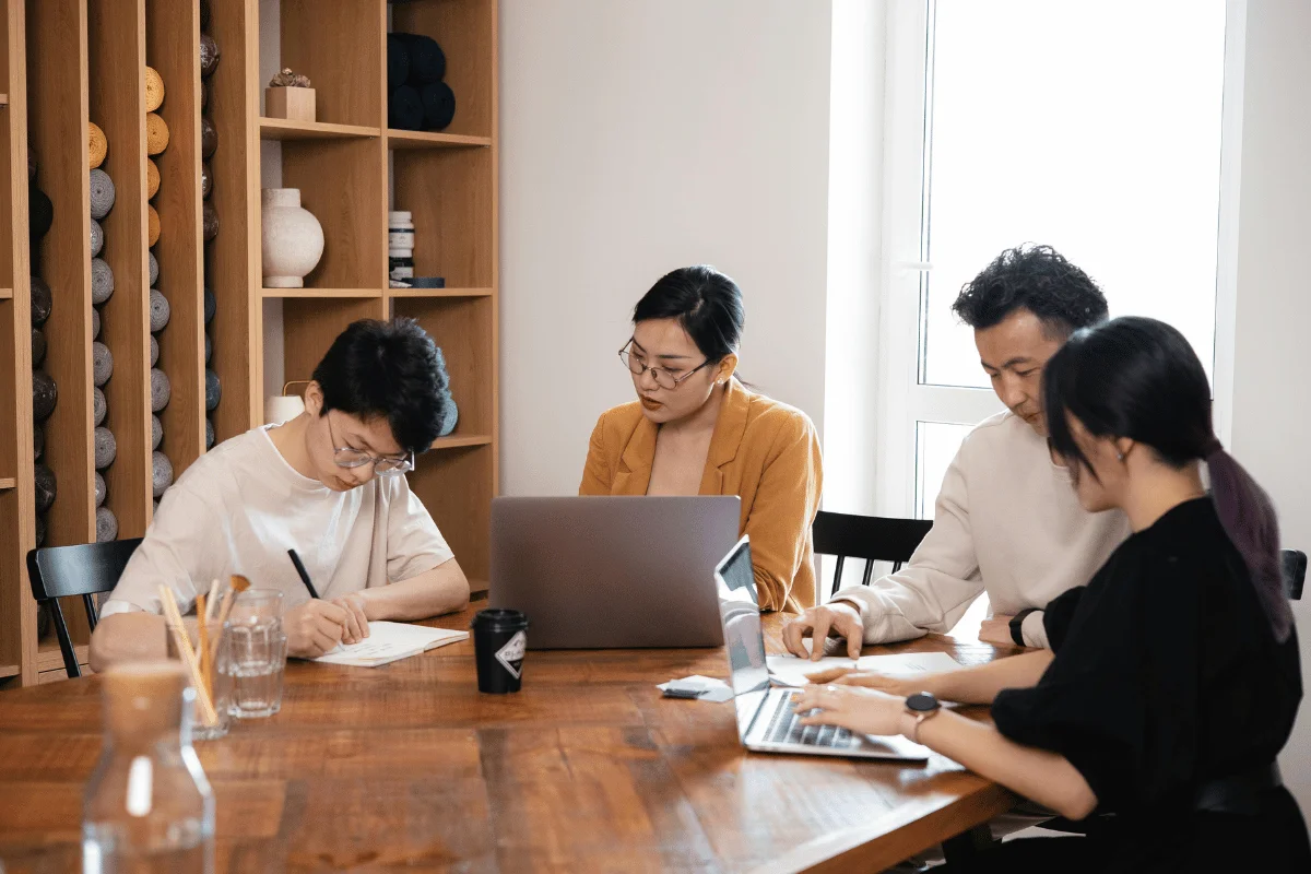 Group of colleagues working together on financial planning documents.