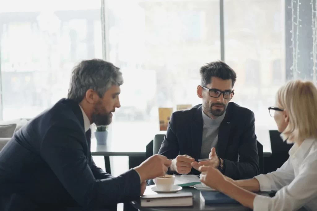 Team of colleagues discussing strategy over coffee.